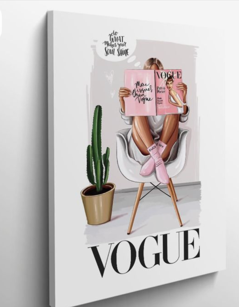 Vogue magazine cover with a person holding two copies, featuring a cactus plant on a white background.