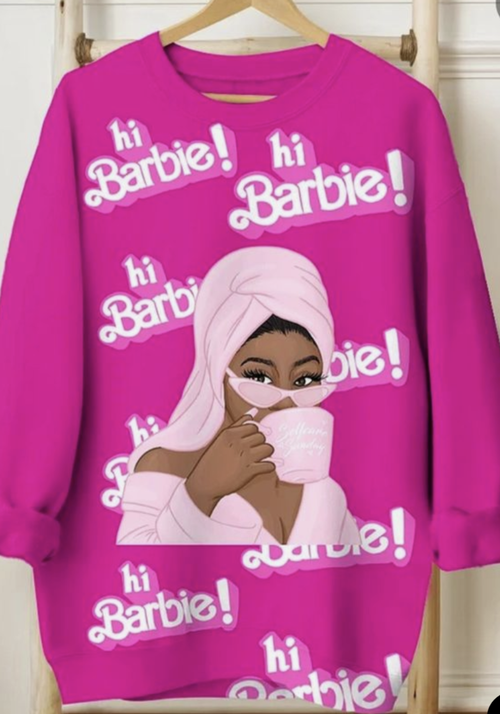 Pink sweatshirt with 'hi Barbie!' text and a graphic of a person wearing a hijab on a hanger.